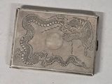a silver box with a dragon and a dragon on it