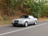a silver car that is driving down the road