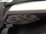 a close up of a bag with a book inside of it