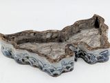 a small blue and white bowl sitting on a white surface