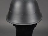 a close up of a metal helmet on a black base
