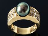 an image of a black pearl and diamond ring on a black surface