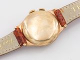 an image of a wrist watch with a gold dial and brown leather strap