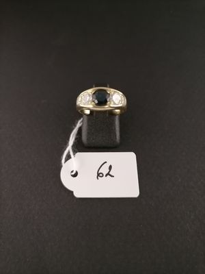 a black and white diamond ring with a price tag on a black surface