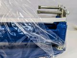 a blue and white cooler sitting on a table covered in plastic