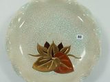 une assiette blanche ornée d'une feuille d'or