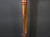 an image of a wooden pedestal with a marble top on a gray surface