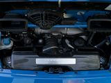a blue car with a engine in the trunk of it