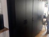 a large black cabinet in the middle of a room