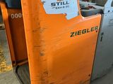 a forklift that is sitting next to a forklift