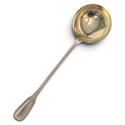 a spoon with a spoon rest on it on a white surface
