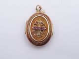 an image of a gold locke with a pink stone in the center