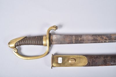 an old sword with a brass handle on a white surface