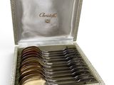 an assortment of silverware in a box on a white surface