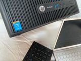two laptops and a desktop computer sitting on a table