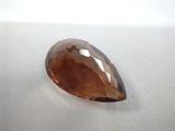 a close up of a large brown stone on a white surface