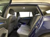 the interior of a car with the door open and the driver ' s seat down