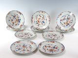 several plates and bowls are arranged on a white surface