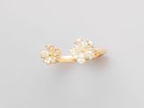 an image of a gold ring with three white diamonds