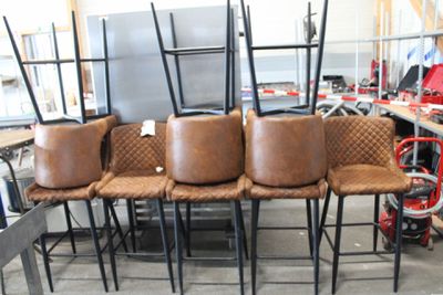 four chairs sitting on top of each other in a room