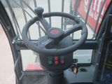 a steering wheel on a bus that is driving down the street