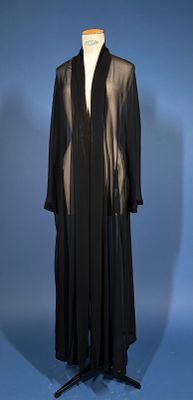 an image of a black dress on a mannequin stand