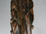 a wooden sculpture of a bird on a branch