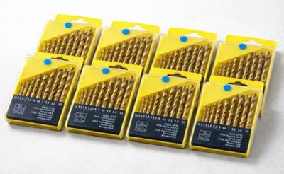 a set of six gold drill drills in a yellow box