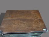 a wooden chest of drawers with a drawer underneath it