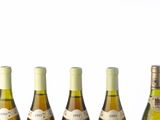 several bottles of wine are lined up on a table