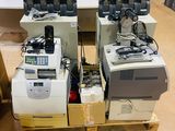 several cell phones are sitting on top of a pallet in a warehouse