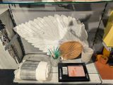 a shelf with a lamp, a book, a vase, and other items on it