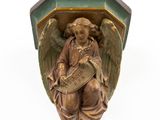 an image of a statue of an angel holding a sign