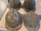 three helmets are sitting on a cardboard box in a warehouse
