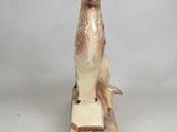 figurine of a deer with antlers on a wooden base