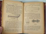 someone is holding an open book with diagrams and diagrams on it