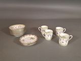 a lot of cups and saucers sitting on a table