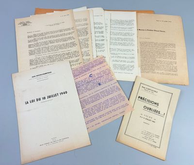 some old papers are piled on top of each other on a table