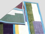 an image of a multicolored rug on a gray background