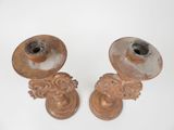pair of antique cast iron candlesticks on white background