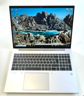 a laptop computer sitting on top of a white table