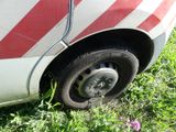 a red and white striped car that is parked in the grass