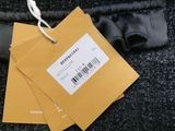 a tag on a black jacket with a black belt