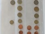 a lot of coins in a plastic container on a table