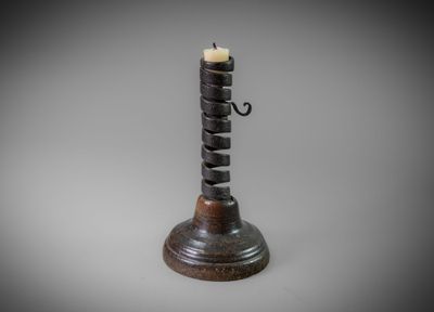 a small candle holder with a candle on top of it