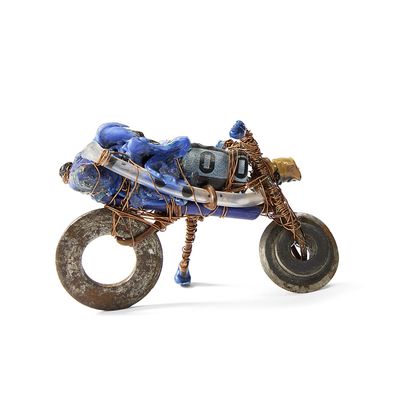 a toy motorcycle made out of a tire with a bag on the back of it