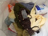 a bag full of clothes and toilet paper in a trash can