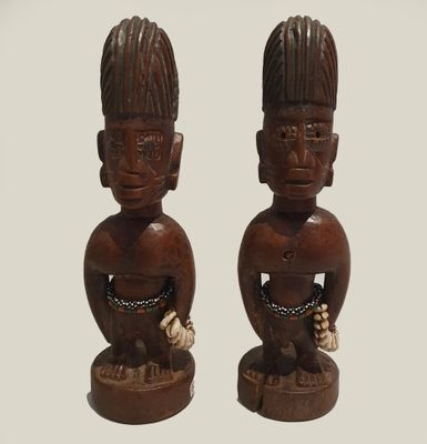 pair of wooden figurines of a man and a woman