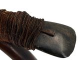 rope wrapped around the handle of a walking stick on a white background
