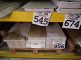 boxes of wood are stacked on pallets for sale at a store